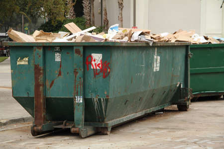 Two dumspters containing trash outside.の写真素材
