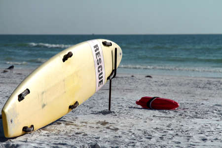 Rescue surfboard on a white sandy beach at Siesta Beach, Florida.の写真素材