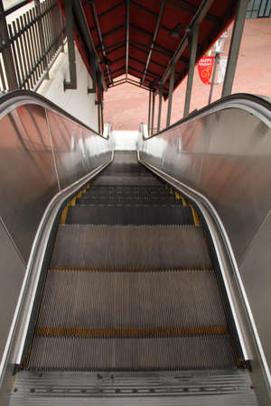 Escalator going down outside with no people on it.の写真素材