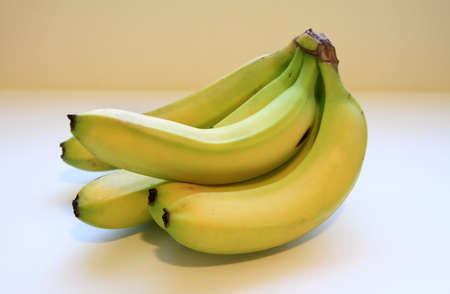 Yellow bananas sitting on a white background.の写真素材