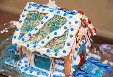 A blue and white themed gingerbread house made during the Christmas season.の写真素材