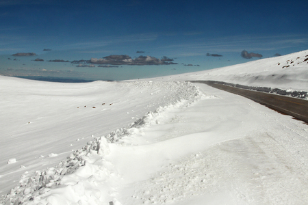 Snow all around the road on the top of the mountain at Pike's Peak in Colorado.の写真素材