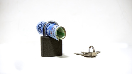 Padlock and money on white backgroundの写真素材