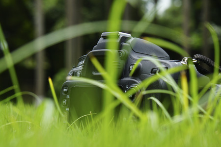 Rear view of camera on grass backgroundの写真素材