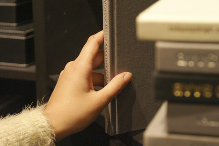 Hand Reaching for Book on Shelf In Libraryのeditorial素材