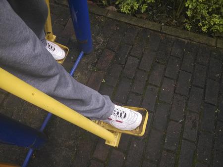 A man wearing sweatpants and shoe exercising in a recreation parkの写真素材