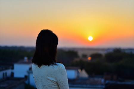Young woman in rural rooftop enjoy the sunsetの写真素材