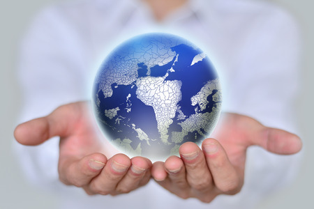 Man holding globe on his handsの写真素材