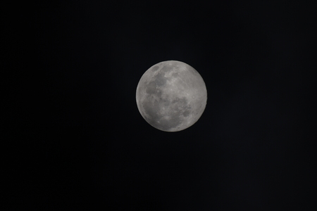 Moon through telescope with visible craters and the sea of tranquility.の写真素材