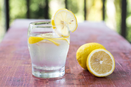 Lemonade with fresh lemon on wooden backgroundの写真素材
