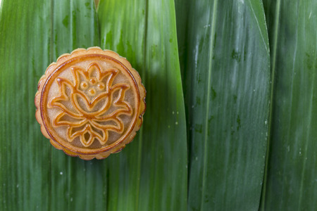 A mooncake on the background of the bamboo tile