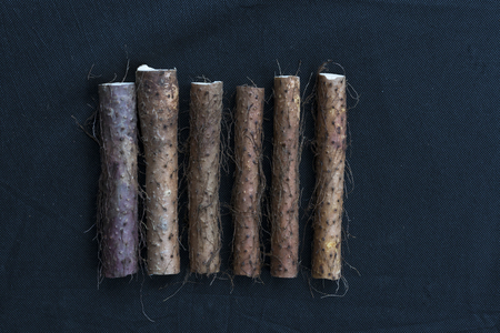 Yam placed on the background of black linenの写真素材