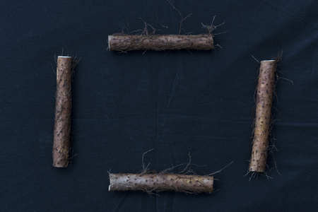 Yam placed on the background of black linenの写真素材