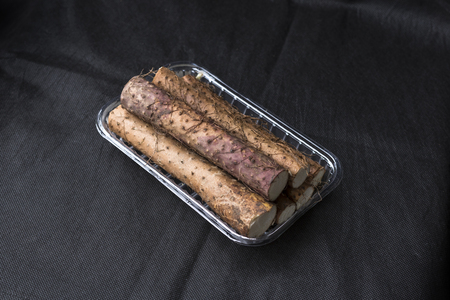 Yam placed on the background of black linenの写真素材