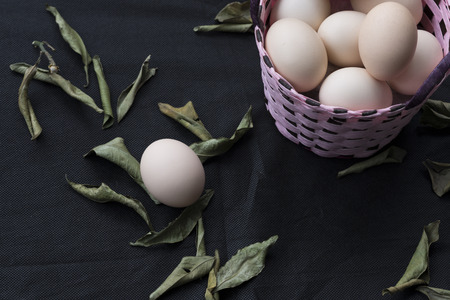 eggs in a basket on black background