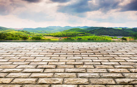 Unmanned stone brick square platform and tranquil natural landscape.の写真素材