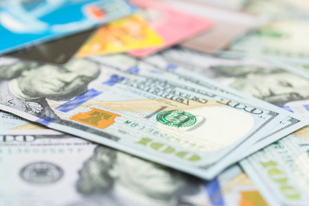 Dollars and credit cards on the table, close-upの写真素材