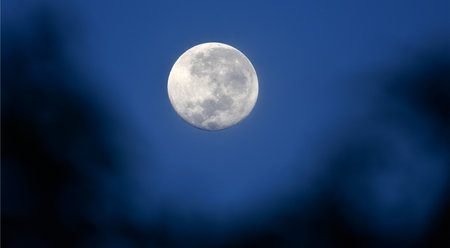Full moon in the night sky with dark clouds. Abstract background.の写真素材