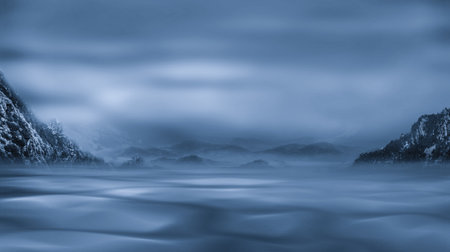 Winter landscape with a frozen lake and mountains in the distance. Long exposureの写真素材