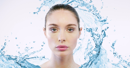 Close-up of a woman without imperfections, wrinkles and greasy skin, in short with perfect skin thanks to the creams and detergents in front of her face.の写真素材