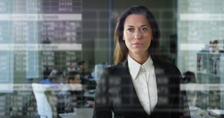 The future connection of people through hologram, communication and sending of important files, the business lady in the office, holds the phone, trading and selling (shares) .Concept: future technologiesの写真素材