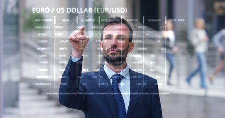 A businessman in a suit uses holography and augmented reality in 3D graphics financial economics....