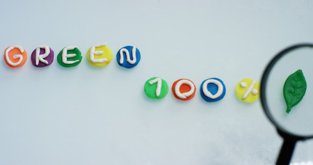 A magnifying glass over the word "search" done in a creative and artistic as children. Concept of research, protected sites, creativity and colorの写真素材