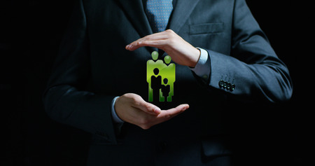 A man in a suit and tie appears in his hands. Concept of: family, home applications, and futureの写真素材