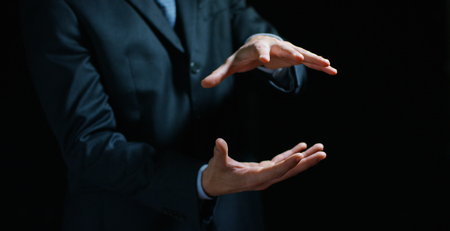 a businessman in a suit holding his hands in position to implement the graphic. Concept; Immersive technology, augmented reality.の写真素材