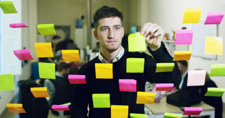 Portrait of a smiling boy in a creative office. Concept: team work, agency, creative, business