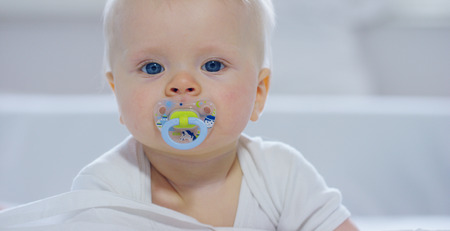 A baby boy with large blue eyes and light colored hair. Concept: children, kids, baby, babies, a new generation.の写真素材
