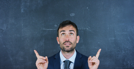 Portrait of a beautiful business man with a marketing teacher, thinking about new ideas and strategies. Concept: career growth, growth chart, successful girl, marketing, ideas.の写真素材