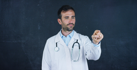 The portrait of the professor, the doctor (student) stands at the black board. Concept: ideas, professions, university, chemistry, science teachers memory biology doctor collegeの写真素材