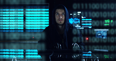 Hacker tries to enter the system using codes and numbers to find the security password.The hacker...