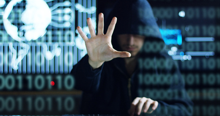 Hacker tries to enter the system using codes and numbers to find the security password.The hacker enters the software to steal login information.Concept: immersive technology, augmented realityの写真素材