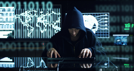 Hacker tries to enter the system using codes and numbers to find the security password.The hacker...