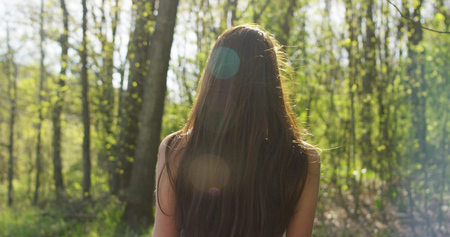 young woman breathing in nature in the sun