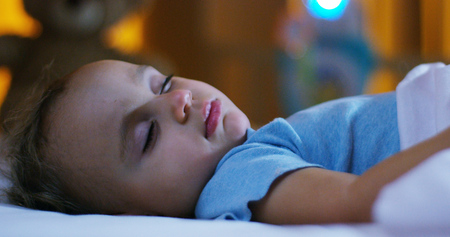 The baby is sleeping happy and carefree, concept of comfort and home, night and sweet dreams, no...
