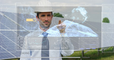 A futuristic engineer-expert in solar photovoltaic panels, uses hologram with remote control, performs complex actions to monitor the system using clean renewable energy remote support technologiesの写真素材