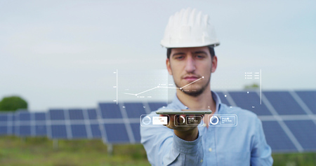 In a field photovoltaic solar panels an engineer, thanks to holography and augmented reality....
