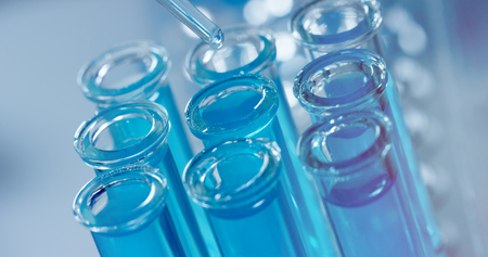 in a laboratory, a scientist with a pipette. Concept: research, biochemistry, nature, pharmaceutical medicineの写真素材