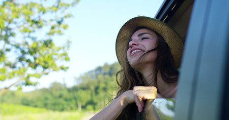 on a sunny day to beautiful woman puts in the airの写真素材