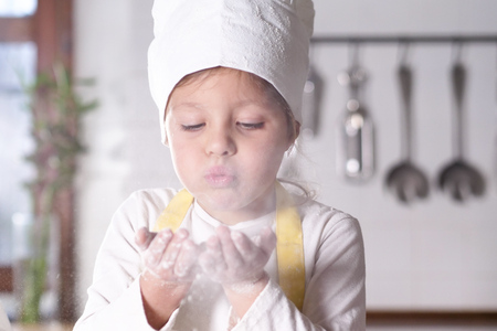 Her boyfriend is in the kitchen, she is a cook, she is a woman, she is in the kitchen. Concept of: nutrition, cooking school, education and game.の写真素材