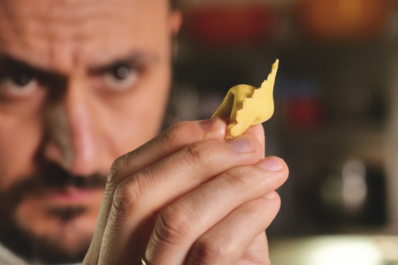 Close-up of a chef preparing ravioli, a typical Italian dish. Concept of tradition, fresh pasta, italian food.の写真素材