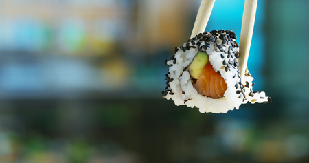 Macro shot of sushi, sashimi, uramaki and nighiri.typical Japanese dish consisting of rice, salmon or tuna, shrimp and fish on black background.Concept: Japanese restaurant, sushi, oriental traditionの写真素材