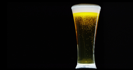 golden icy cold beer in extreme macro foam. clear beverage and bubbles of carbon dioxide. fresh beer of double-hop just poured. concept of fresh and thirst-quenching beer. texture and extreme macroの写真素材