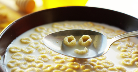 on a sunny day in the garden pours smile in a cup where the cereals falls. concept of healthy food...