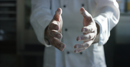 An experienced chef in a professional kitchen prepares the dough with a flour to make the organic Italian pasta. the concept of nature, Italy, food, diet and bio.の写真素材