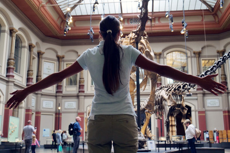 A family goes to see the archeology museum where prehistoric dinosaur skeletons are present. Concept of: educational, family, school, history.の写真素材