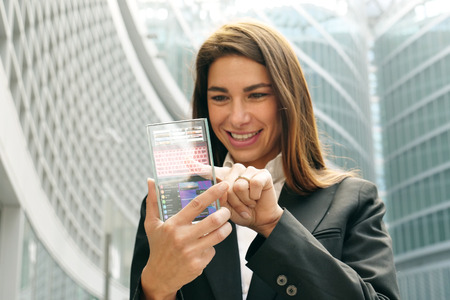 The woman in suit uses a holistic technology.の写真素材